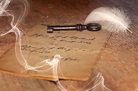 brown metal skeleton key beside white feather thumbnail