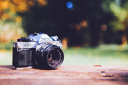 selective focus photography of black and gray Canon AE-1 DSLR camera thumbnail