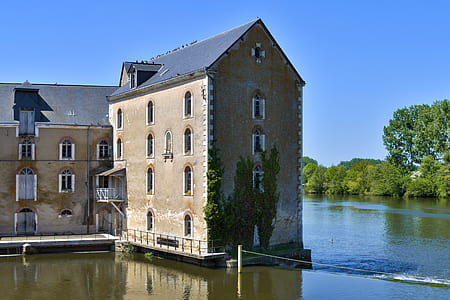 brown and black house near body of water thumbnail