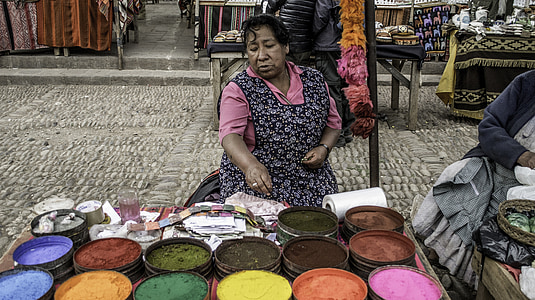 woman selling different colored grains thumbnail