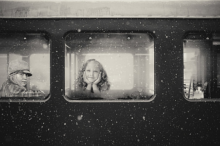 grascale photo of girl inside train thumbnail