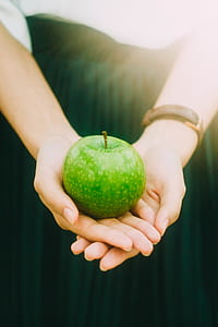green apple on person's hand thumbnail