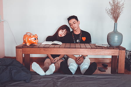 Sitting Woman and Man Wearing Black Crew-neck T-shirts thumbnail