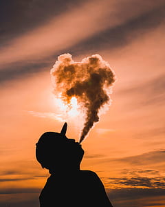 silhouette of man blowing smoke thumbnail