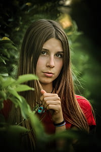 woman wearing red top beside plants at daytime thumbnail
