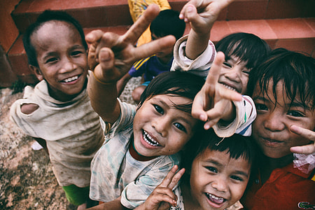 tilt shift lens photography of children's showing their hands thumbnail
