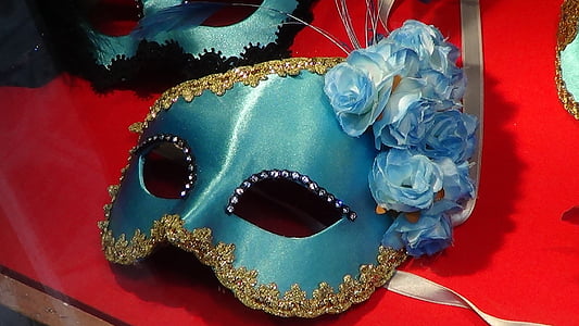 blue masquerade mask on top of red table thumbnail