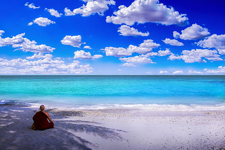 woman sitting on side facing through calm body of water during daytime thumbnail