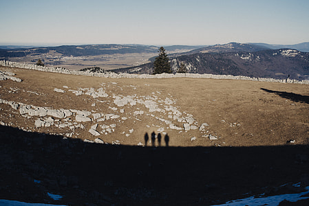 silhouette of four persons on brown open field during daytime thumbnail