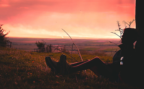 silhouette photo of man leaning on tree thumbnail