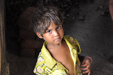 boy wearing yellow shirt standing on gray ground thumbnail