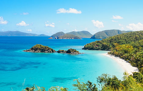 blue and green island under blue sky thumbnail