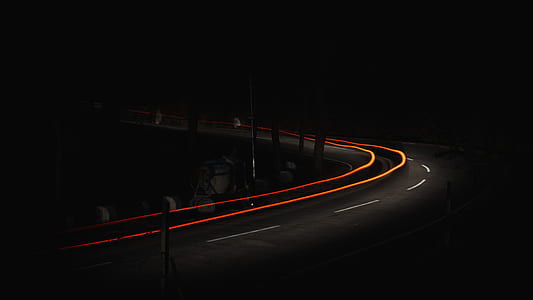 time-lapse photography of vehicle on winding road thumbnail