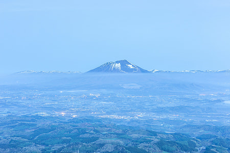 volcano in body of water during daytime thumbnail