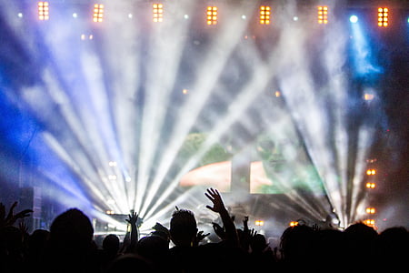 crowd watching a concert with spotlight thumbnail