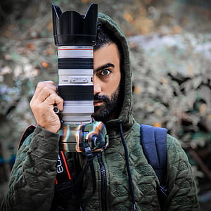 Person Holding a Dslr Camera thumbnail