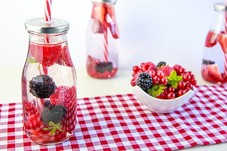 fruit juice bottle on red and white table cover thumbnail