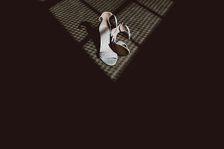 pair of white ankle-strap sandals on brown surface thumbnail
