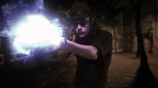 man wearing black hat and firing a gun thumbnail