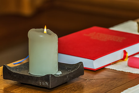 blue candle pillar near red book thumbnail