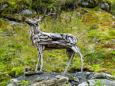 photo of brown wooden deer sculpture thumbnail