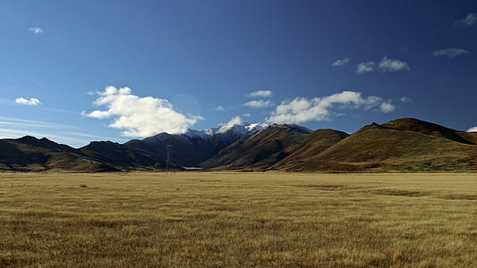 empty green field with mountains thumbnail