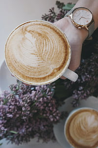 person holding white ceramic mug filled with cappuccino thumbnail