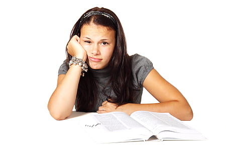 Woman in Black T-shirt Leaning on White Table in Front of White Book thumbnail