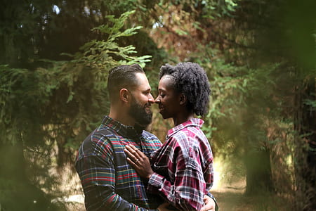 man hugging woman with green trees in the background thumbnail