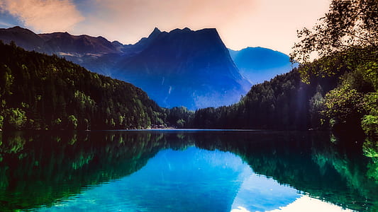 lake surrounded by mountains and forest trees thumbnail