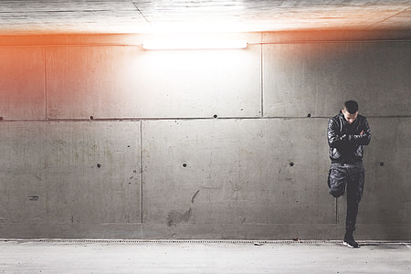 Young Man Standing In Front of Concrete Wall thumbnail