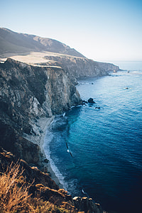 aerial photography of mountain cliff and seashore during daytime thumbnail