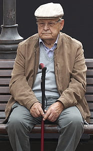 man holding black and red cane thumbnail