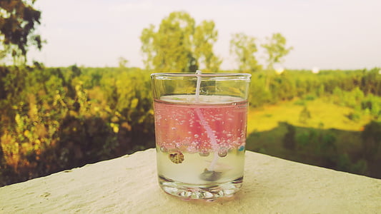 pink and clear liquid in clear drinking glass thumbnail