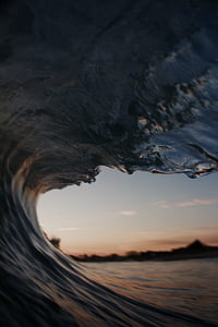 wave of water during golden hour focus photography thumbnail