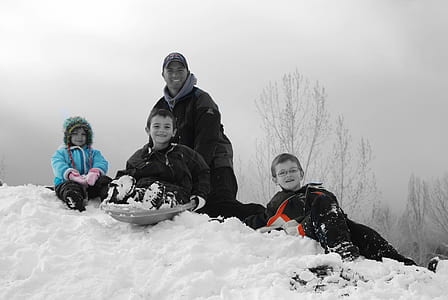 three children sitting on snow thumbnail