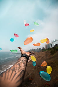 person reaching balloons thumbnail
