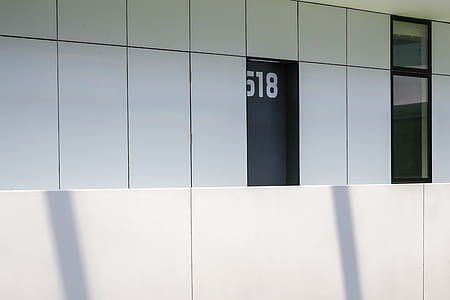 white building with black doors thumbnail
