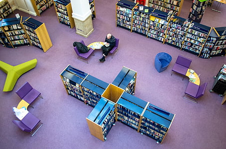 man sitting inside a library thumbnail