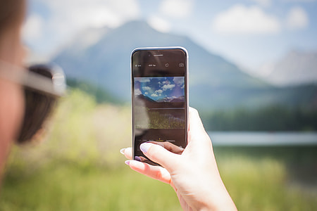 Girl Taking a Photo of Mountains thumbnail