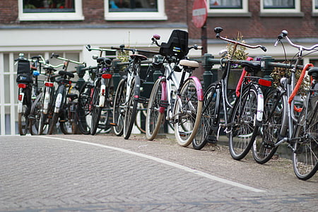 assorted-color bicycles parked on concrete pavement thumbnail
