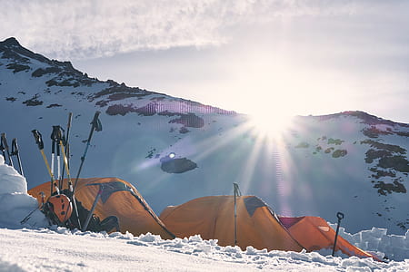 dome tent on snow field near mountain alps under golden hour thumbnail