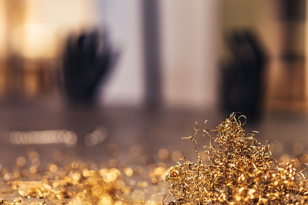 Close-ups of golden metal shavings on a table thumbnail