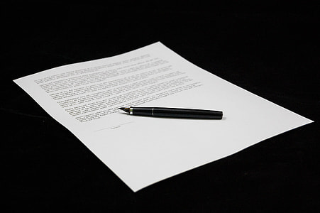 white printed paper with pen on top thumbnail