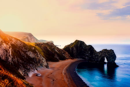 rock cliff beside body of water thumbnail