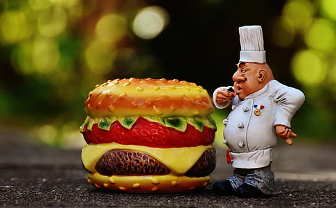 tilt-shift lens photo of a ceramic chef and burger decors thumbnail