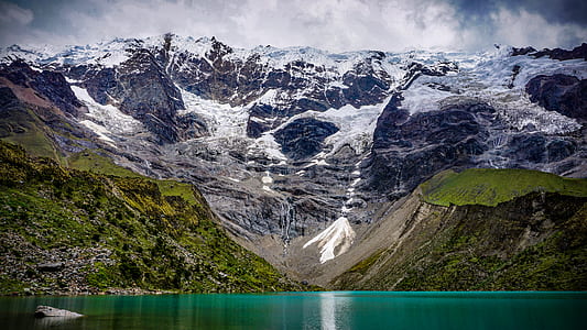 landscape photography of body of water and mountains thumbnail