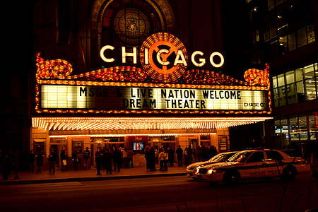 group of people standing outside Chicago cinema theater during night time thumbnail