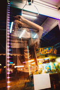 woman in striped shirt leaning on glass thumbnail