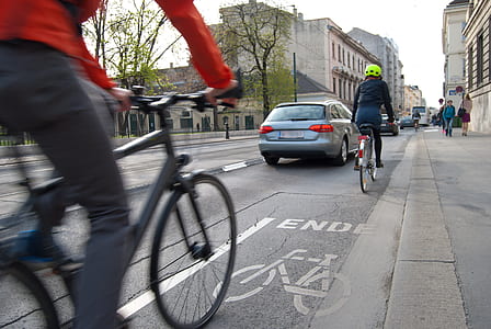 two cyclist on road during daytime thumbnail